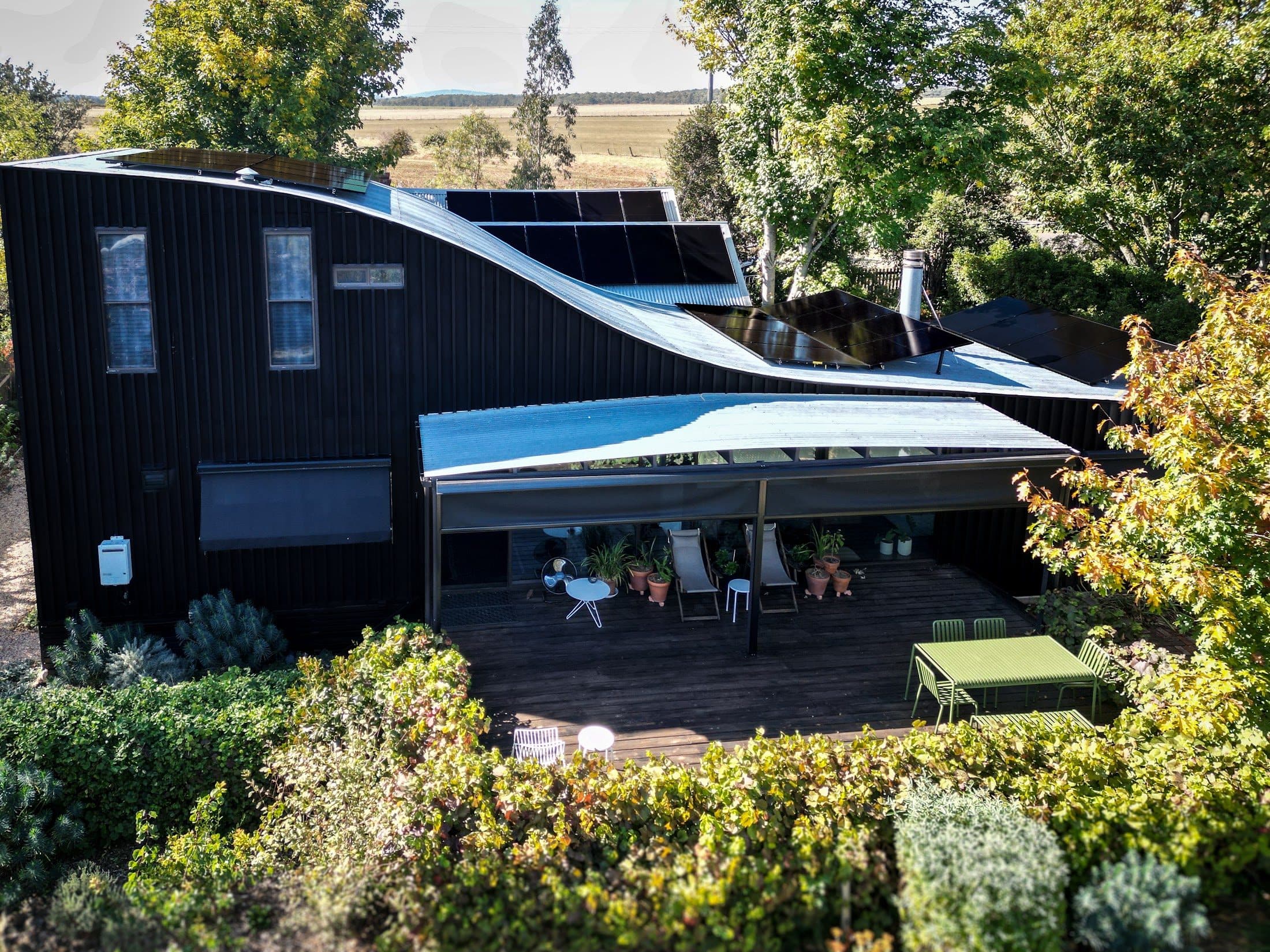 The all black AIKO array running along the curved roofline at 80 East St