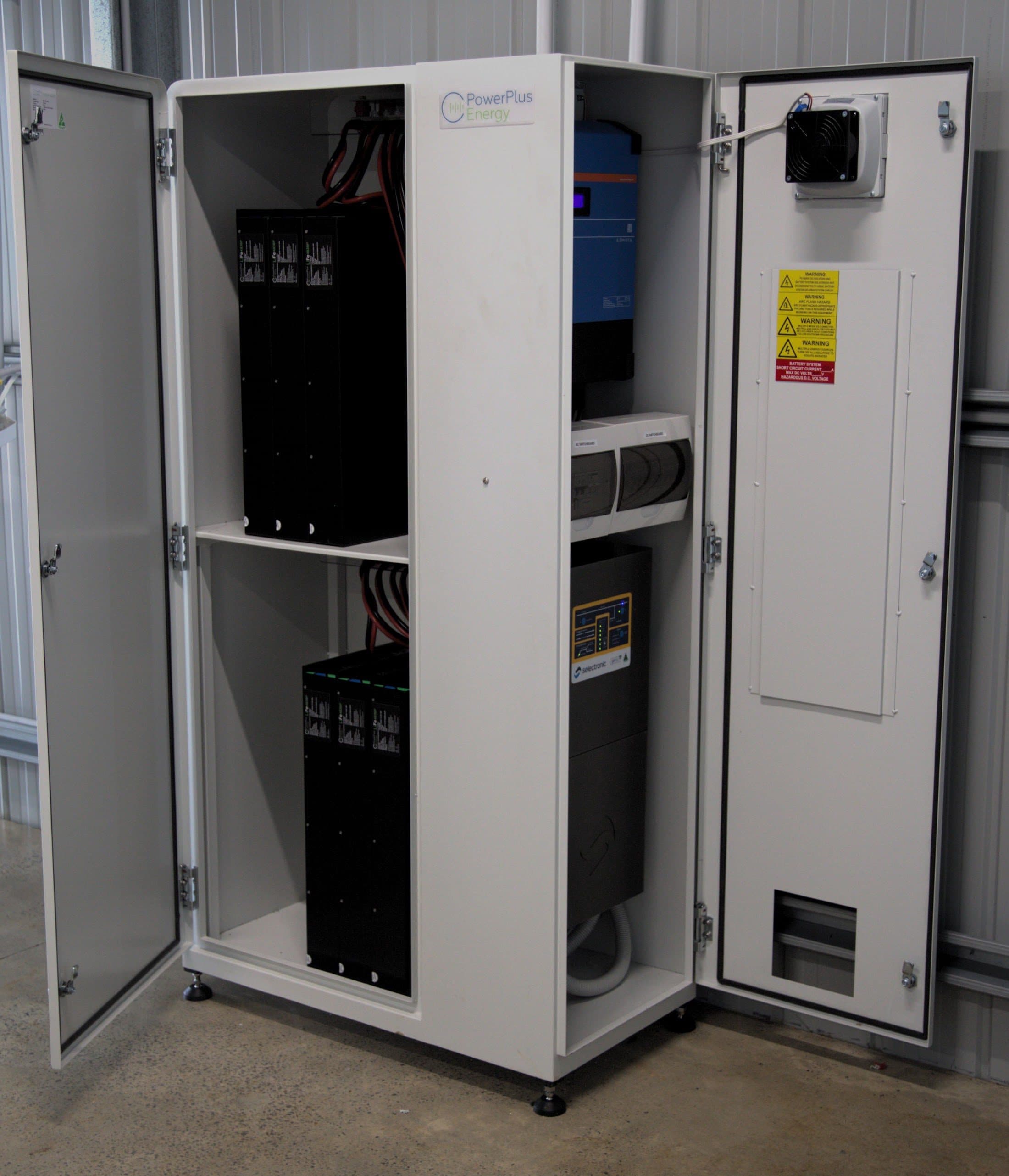 An open PowerPlus battery cabinet with its modules beside a Victron inverter at 132 Parker