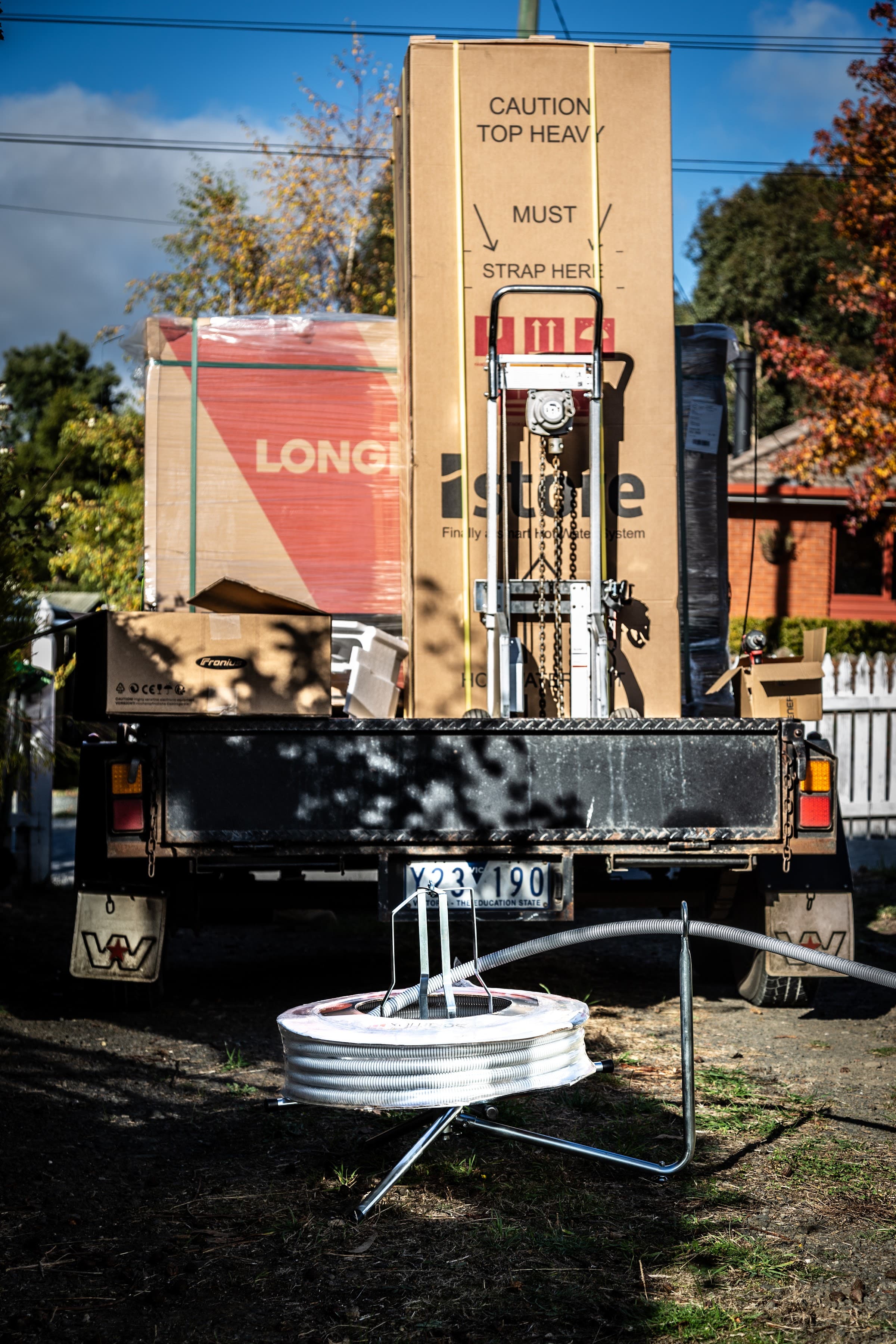 The truck loaded with a full system for the job: panels, a heat-pump hot water unit and an inverter
